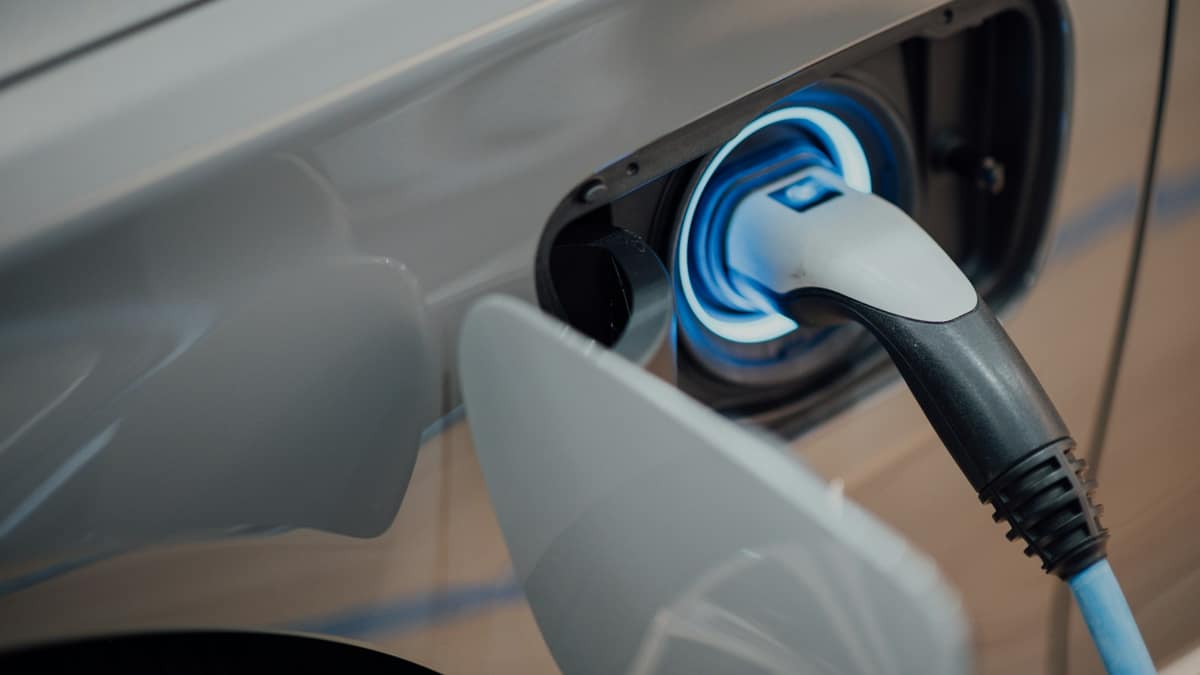 Electric vehicle plugged into a charging station